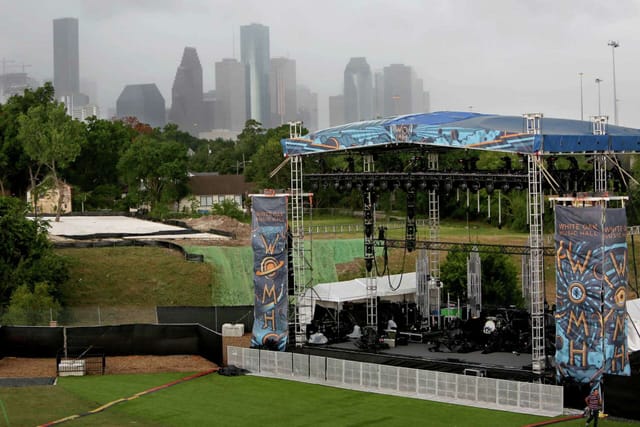 Outdoor event setup at White Oak Music Hall with city skyline backdrop, overcast skies.