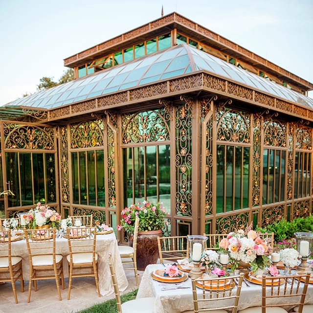 Elegant glass-enclosed conservatory venue for weddings and upscale events.
