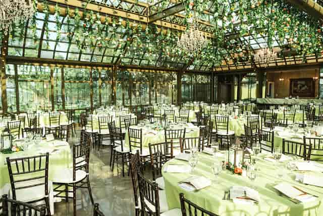 Elegant event space with round tables and greenery at The Bryan Museum for weddings.