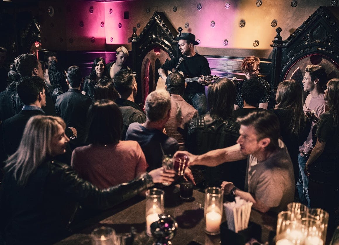 Live music event at Foundation Room, House of Blues Houston, warm lighting, networking.