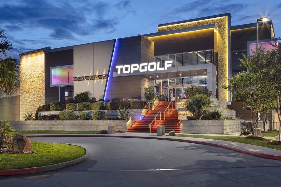 Vibrant Topgolf Houston lounge, ideal for corporate events and team-building activities.
