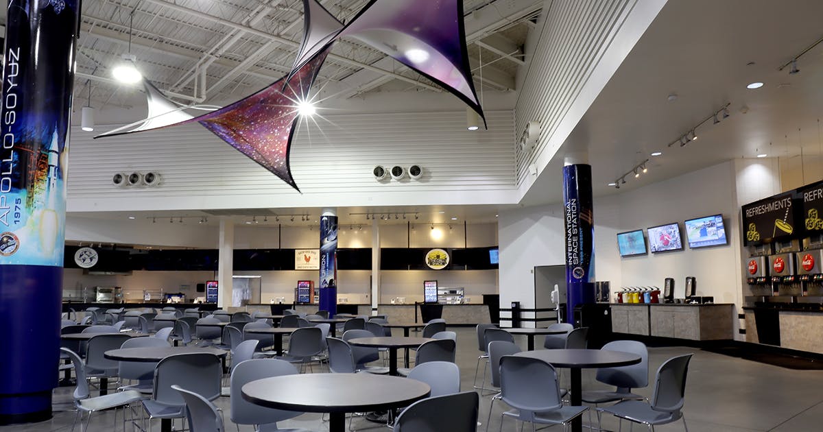 Modern event space at Space Center Houston with sleek dining area and unique ceiling design.