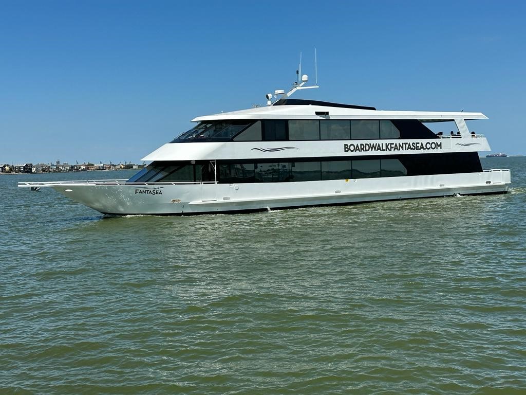Boardwalk FantaSea Yacht gliding through calm waters, ideal for upscale events and gatherings.
