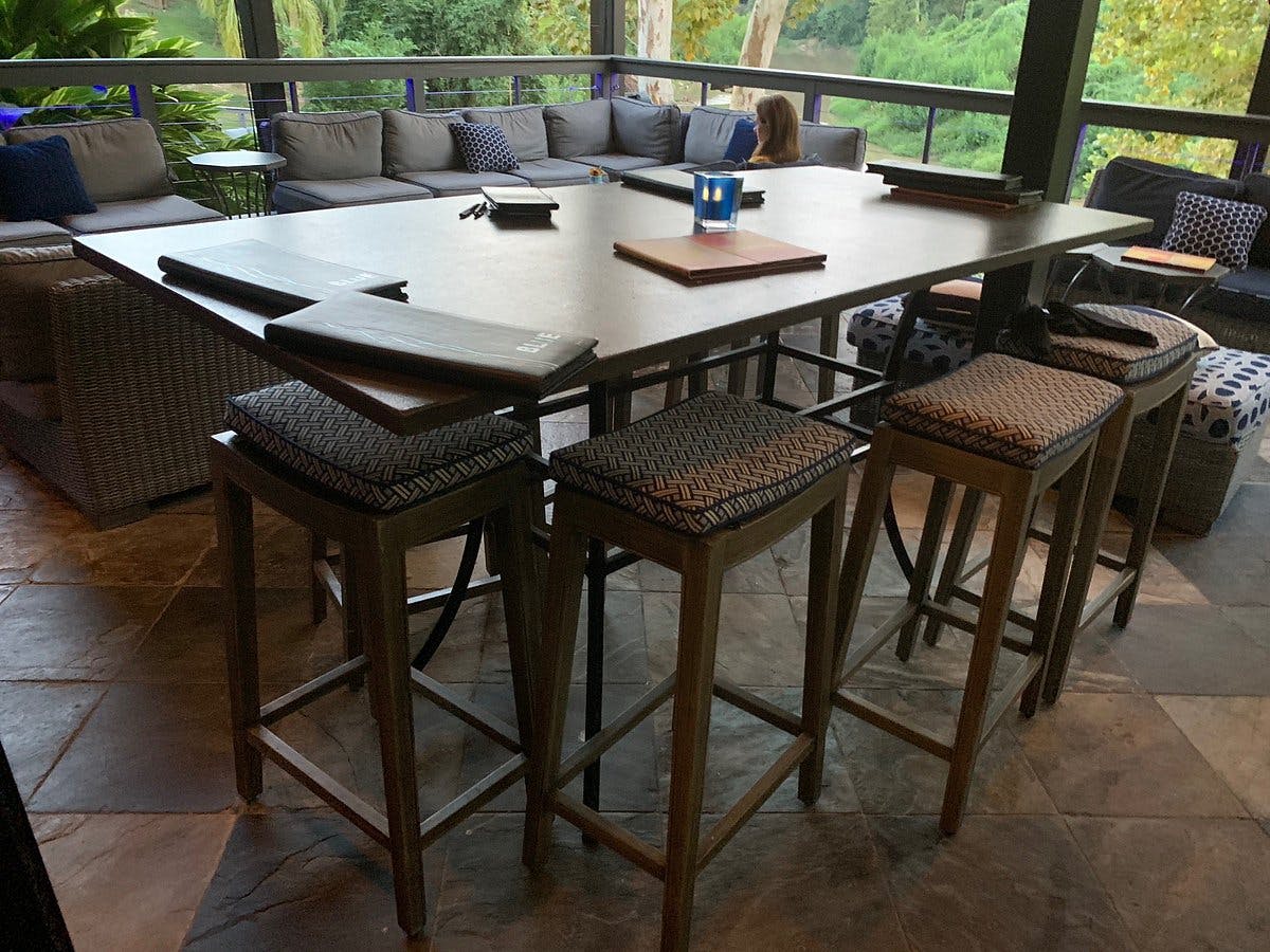 High-top table in stylish lounge at Brenner's On The Bayou for networking events.