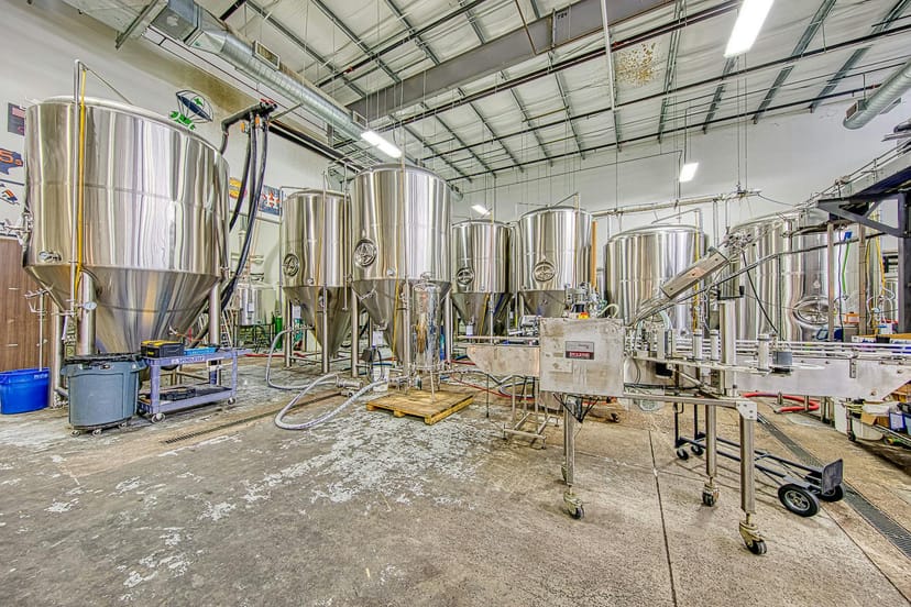 SpindleTap Brewery taproom with stainless steel tanks, perfect for events and gatherings.