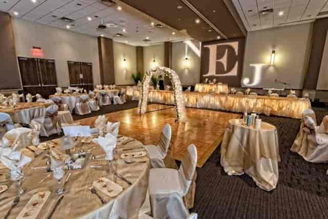 Elegant Red Oak Ballroom with floral arch, ideal for weddings and formal events.