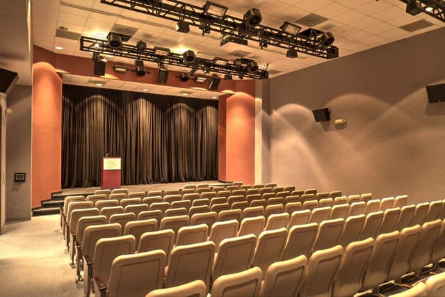 Auditorium with tiered seating at The Health Museum for events and presentations.