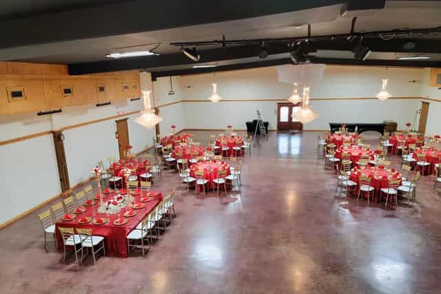 Elegant live music venue with red and white decor, perfect for weddings and corporate events.