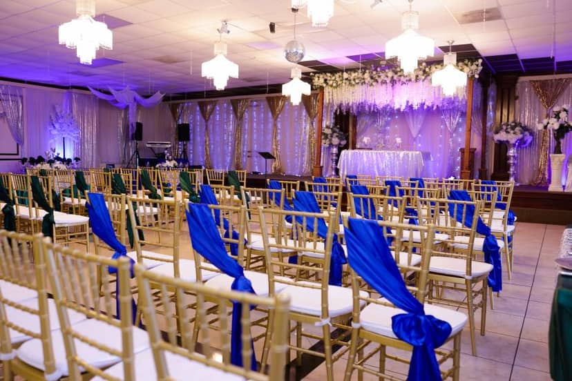 Elegant live music venue with gold chairs and blue sashes, ideal for weddings and events.
