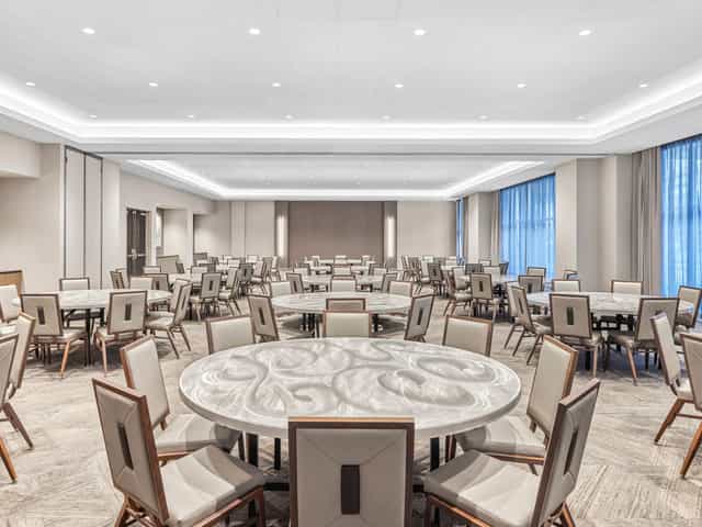 Elegant Main Event Room with round tables, perfect for corporate events and gatherings.