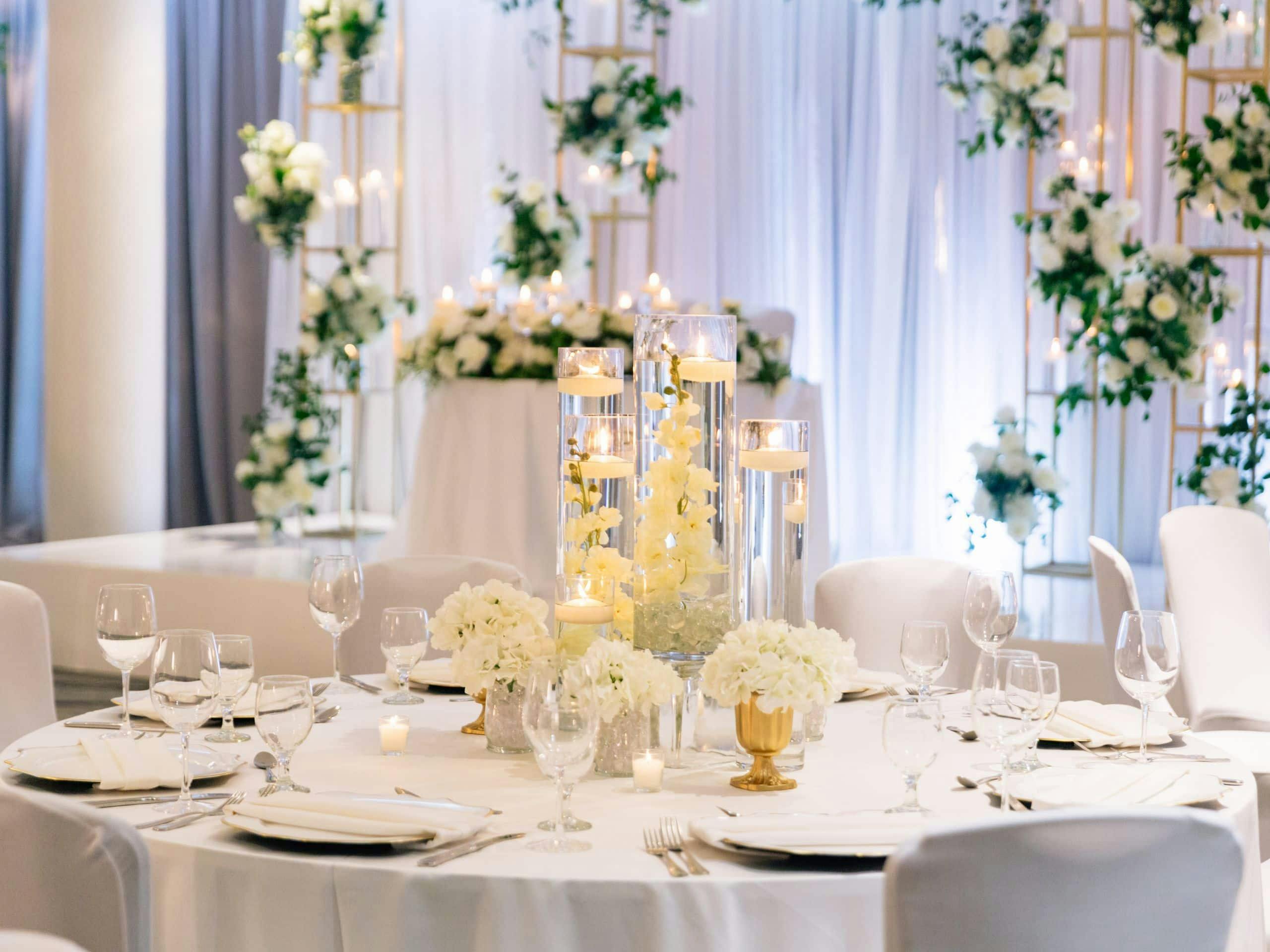 Elegant table setting with floral arrangements in Grand Lobby, perfect for weddings and upscale events.