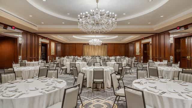 Elegant River Oaks banquet hall with round tables, perfect for corporate events and celebrations.