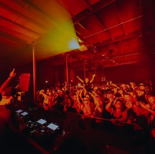 Vibrant nightlife at TESTBED with energetic crowd enjoying a DJ performance.