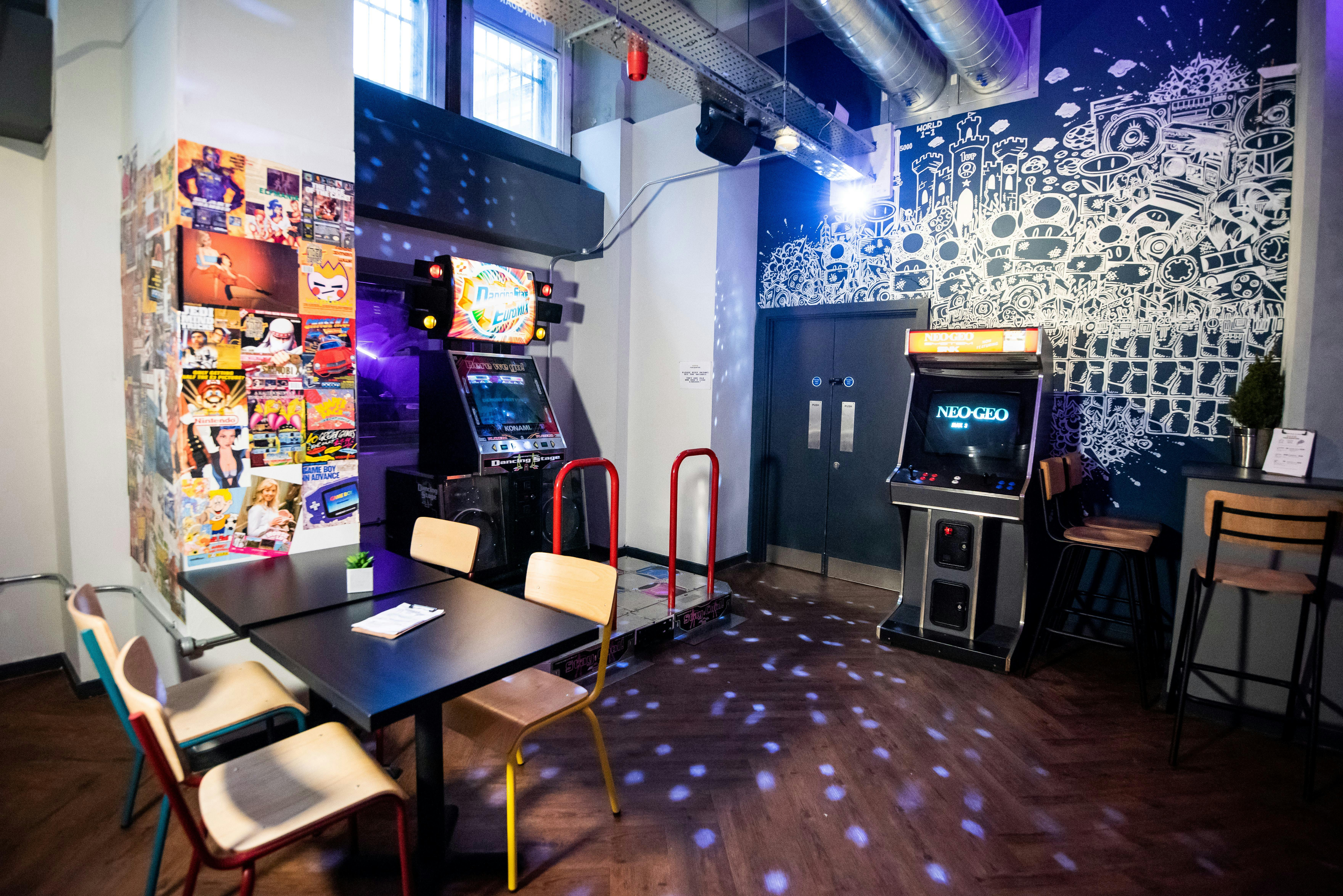 Vibrant event space with bar and arcade games in Four Quarters Newcastle for social gatherings.