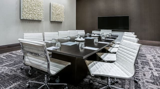 Modern conference room at Embassy Suites Houston for meetings and presentations.