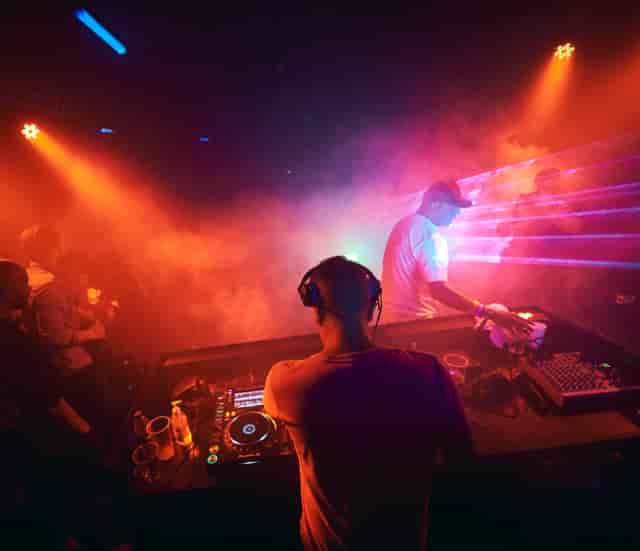 "DJ at P7 Arena Club with dynamic lighting for vibrant nightlife events and parties."