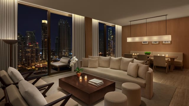 Sleek meeting venue with cozy seating and stunning city views in The Dubai EDITION.