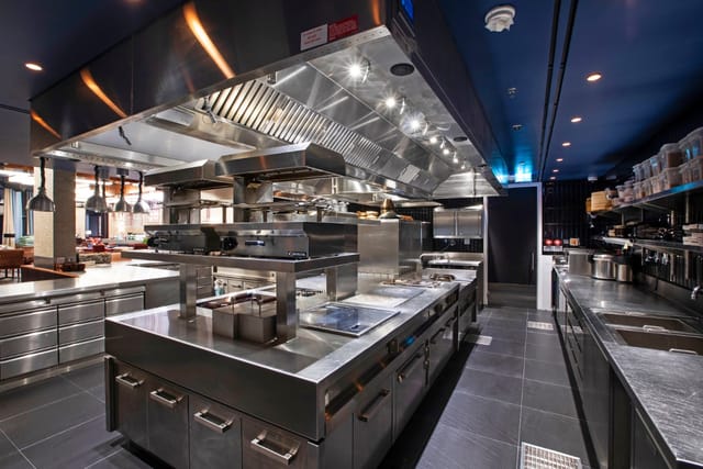 Modern commercial kitchen at Rōhen, The Arts Club Dubai for catering events and demonstrations.