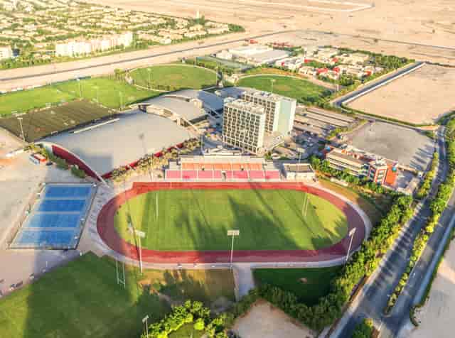 Outdoor Stadium in Dubai Sports City, ideal for events and tournaments with expansive green fields.