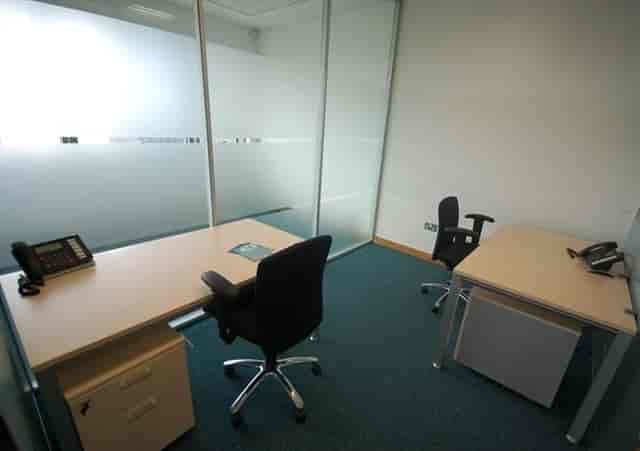 Minimalist meeting room with glass walls for professional team discussions.