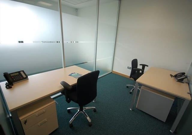 Minimalist meeting room with glass walls for professional team discussions.