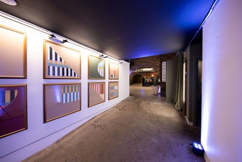 Stylish corridor with modern artwork at Whole Venue, perfect for networking events. - Banner