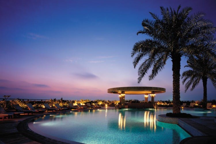 Yasmin at Shangri-La Dubai's outdoor venue with a lit pool, perfect for evening events.