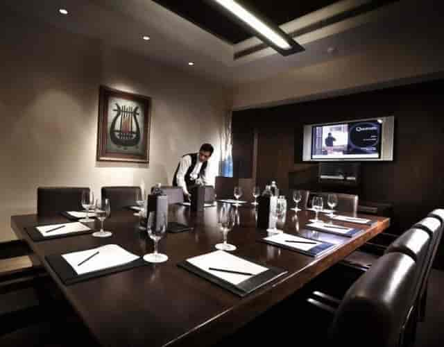 Meeting room at The LaLiT New Delhi with wooden table, ideal for corporate events.