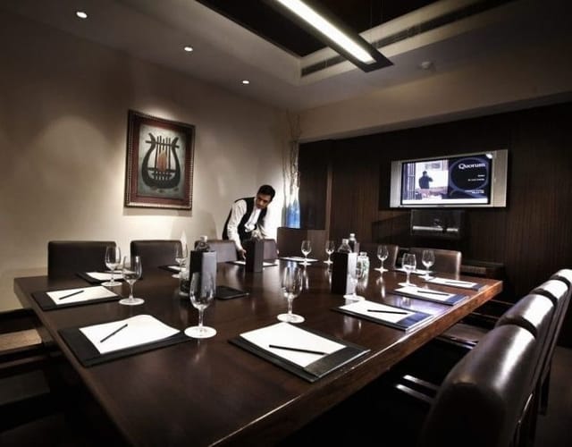 Meeting room at The LaLiT New Delhi with wooden table, ideal for corporate events.