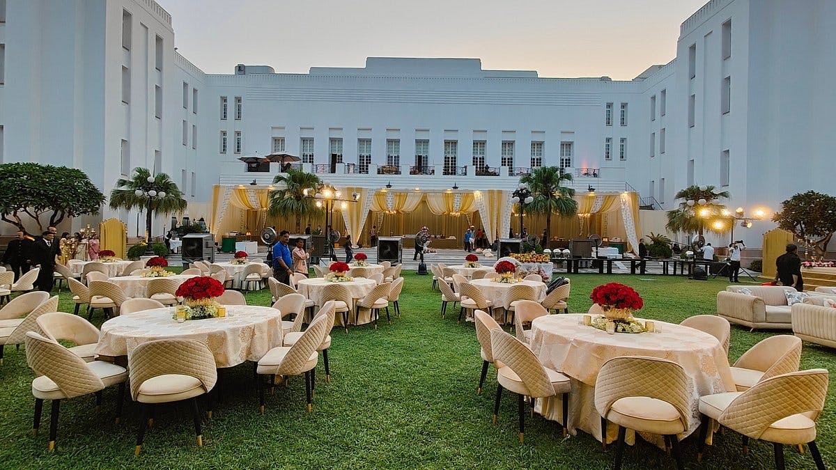 Elegant outdoor event at The Imperial Lawn with floral centerpieces and lush greenery.
