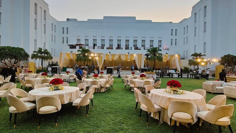Elegant outdoor event at The Imperial Lawn with floral centerpieces and lush greenery.