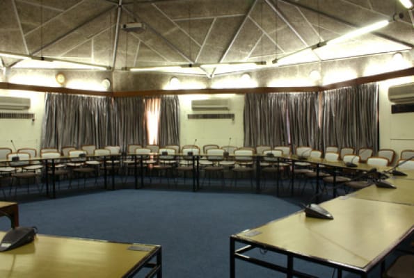 Banquet hall in India Habitat Centre, ideal for workshops and meetings with circular table layout.