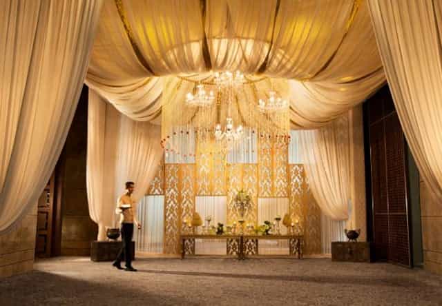 Elegant banquet hall in Aerocity with luxurious lighting for upscale weddings and events.