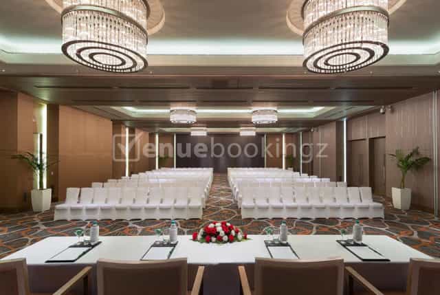 Elegant banquet hall with modern chandeliers for conferences and formal gatherings.