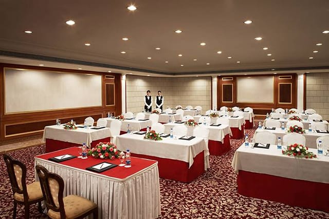 Banquet room at Hotel The Royal Plaza, elegant setup for conferences and workshops.