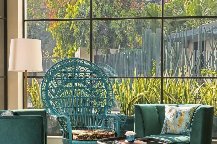 Stylish lounge with teal chair, ideal for networking events and casual gatherings.