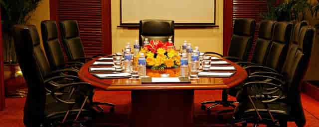 Conference room at Eros Hotel New Delhi with round table, ideal for meetings and events.