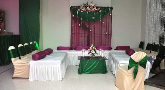 Elegant Banquet Hall at Hotel Regent Grand, with green and burgundy decor for events.