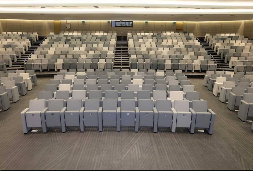 Modern auditorium with tiered seating, ideal for presentations and lectures.