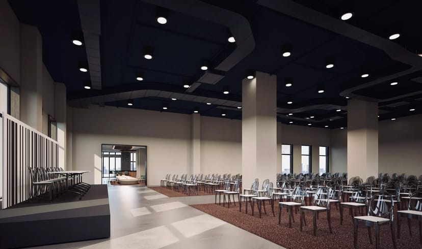 Spacious modern ballroom venue with stage, ideal for conferences and presentations.