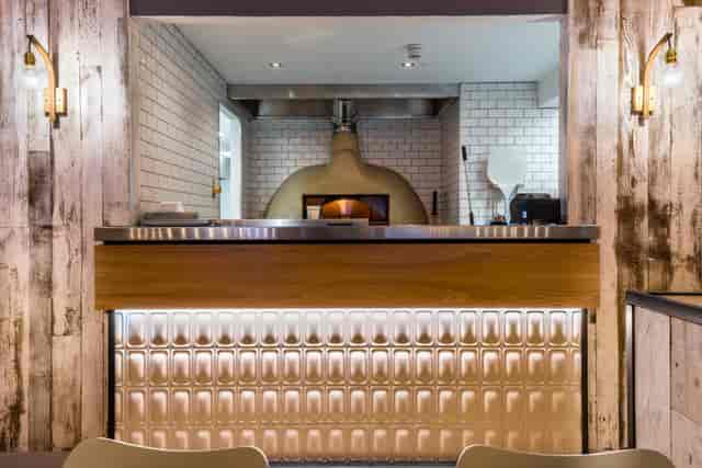 Stylish bar area with rustic wood accents, ideal for networking events and casual meetings.