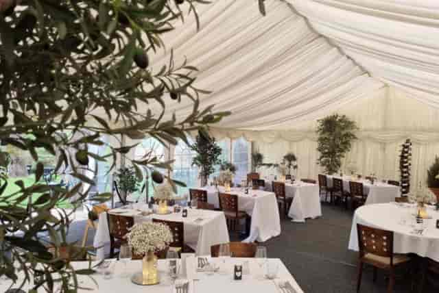 Elegant marquee setting with draped ceilings for weddings and corporate events.