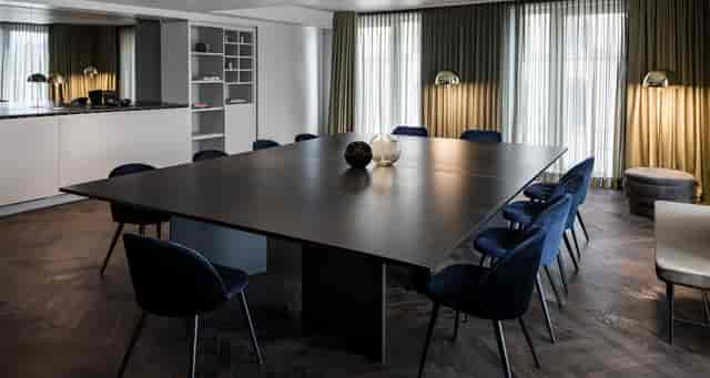 Modern conference room with dark table, perfect for corporate meetings and events.