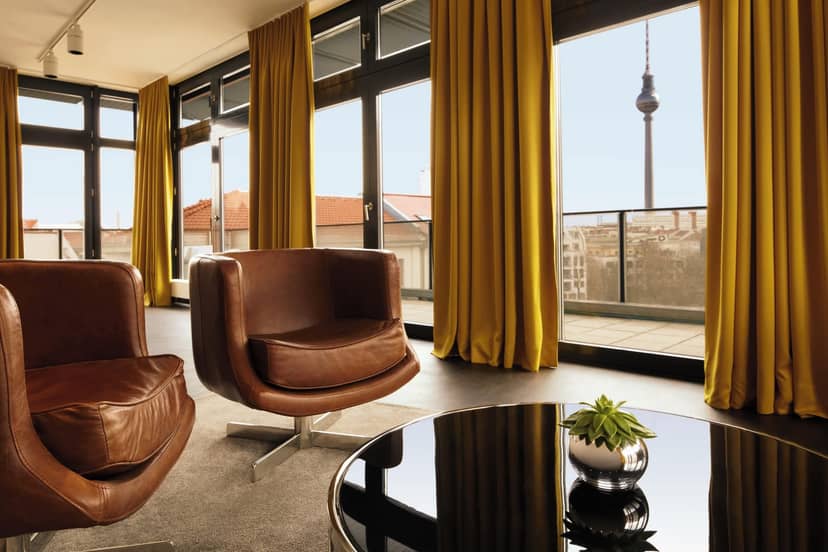 Modern conference room with large windows, brown chairs, perfect for meetings and brainstorming.
