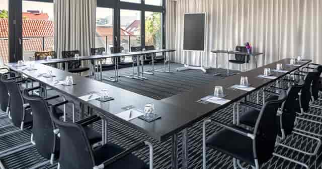Well-appointed U-shaped meeting room for workshops and strategy sessions.