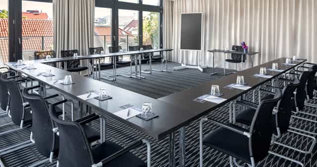 Well-appointed U-shaped meeting room for workshops and strategy sessions.