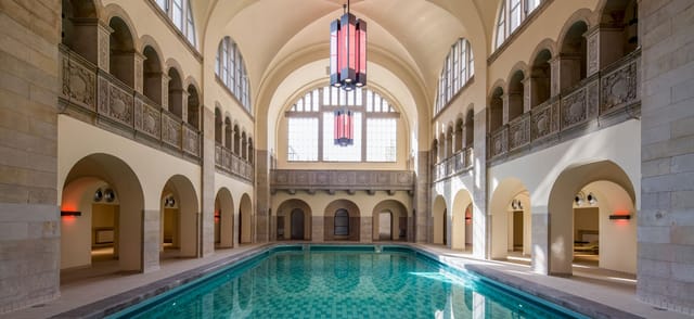 Elegant Stadtbad Oderberger suite with inviting pool, perfect for corporate retreats or wellness events.