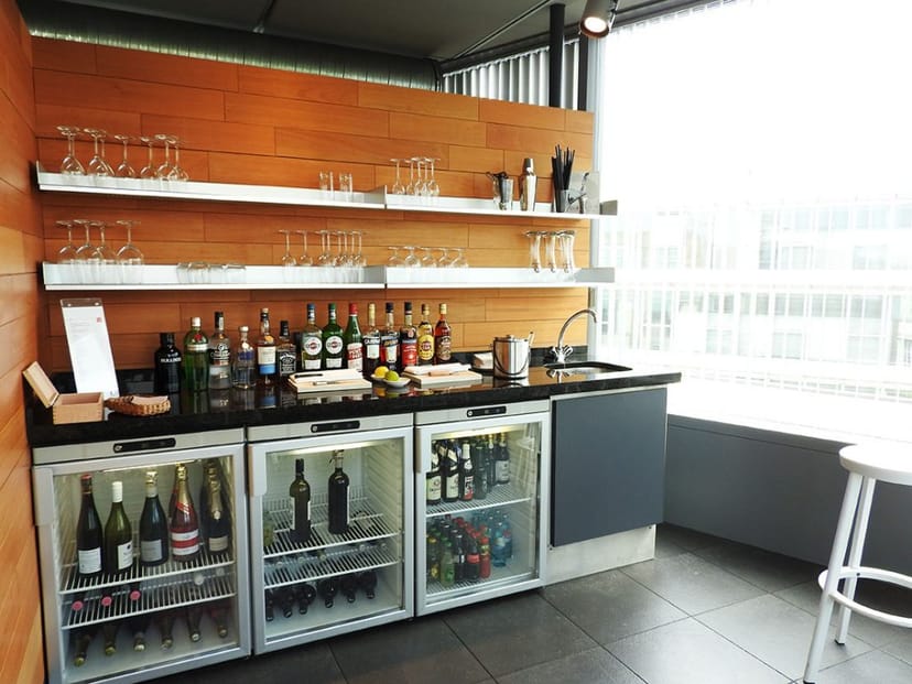 Bar at Casa Camper Berlin with organized shelves, ideal for corporate events and networking.