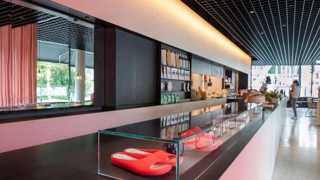 Modern hotel bar reception with sleek décor and stylish red slippers for events.