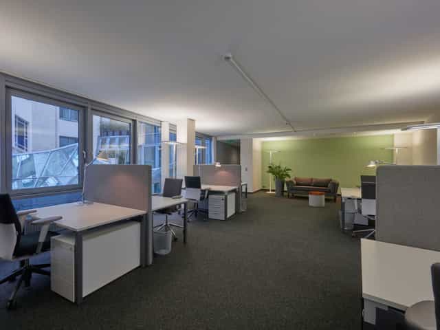 Modern private office space with natural light for productive teamwork and meetings.